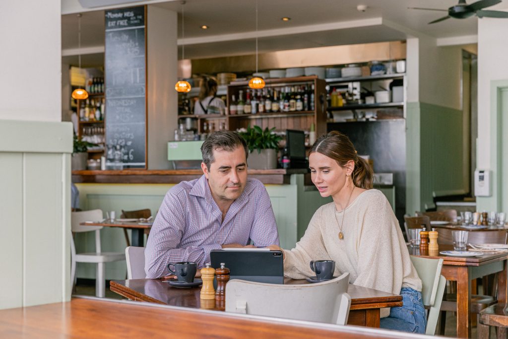 man and woman sitting in café